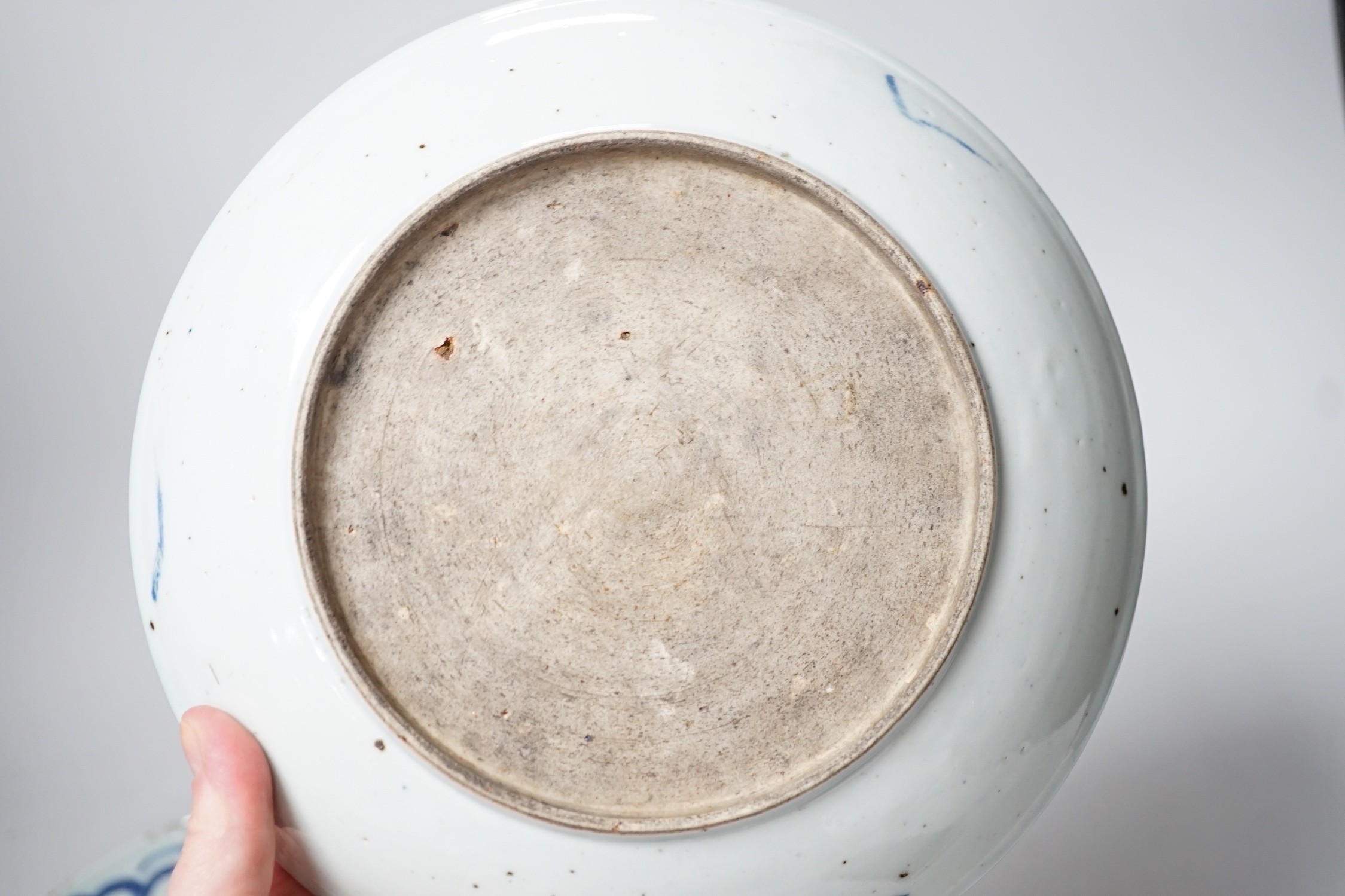 Two 19th century Chinese blue and white dishes and two 18th century tea bowls, largest 23cm diameter